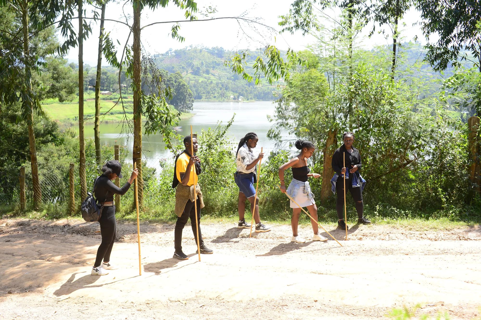 Hikers on the trail with the lake and wooded slopes filling the background