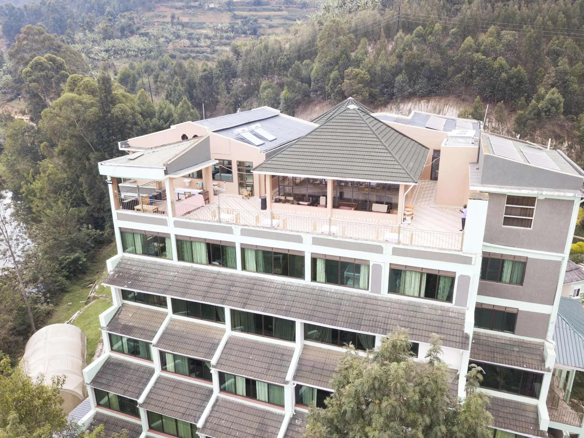 Aerial view of the three-storey hotel block with its balconies and rooftop terrace