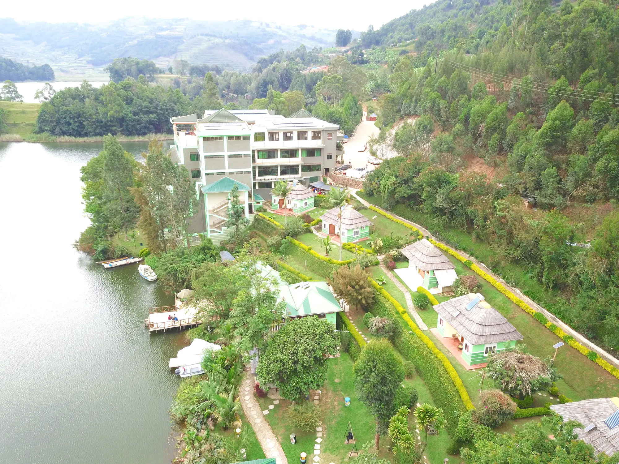 Aerial view of the whole resort on its peninsula, the hotel block above the gardens and jetty