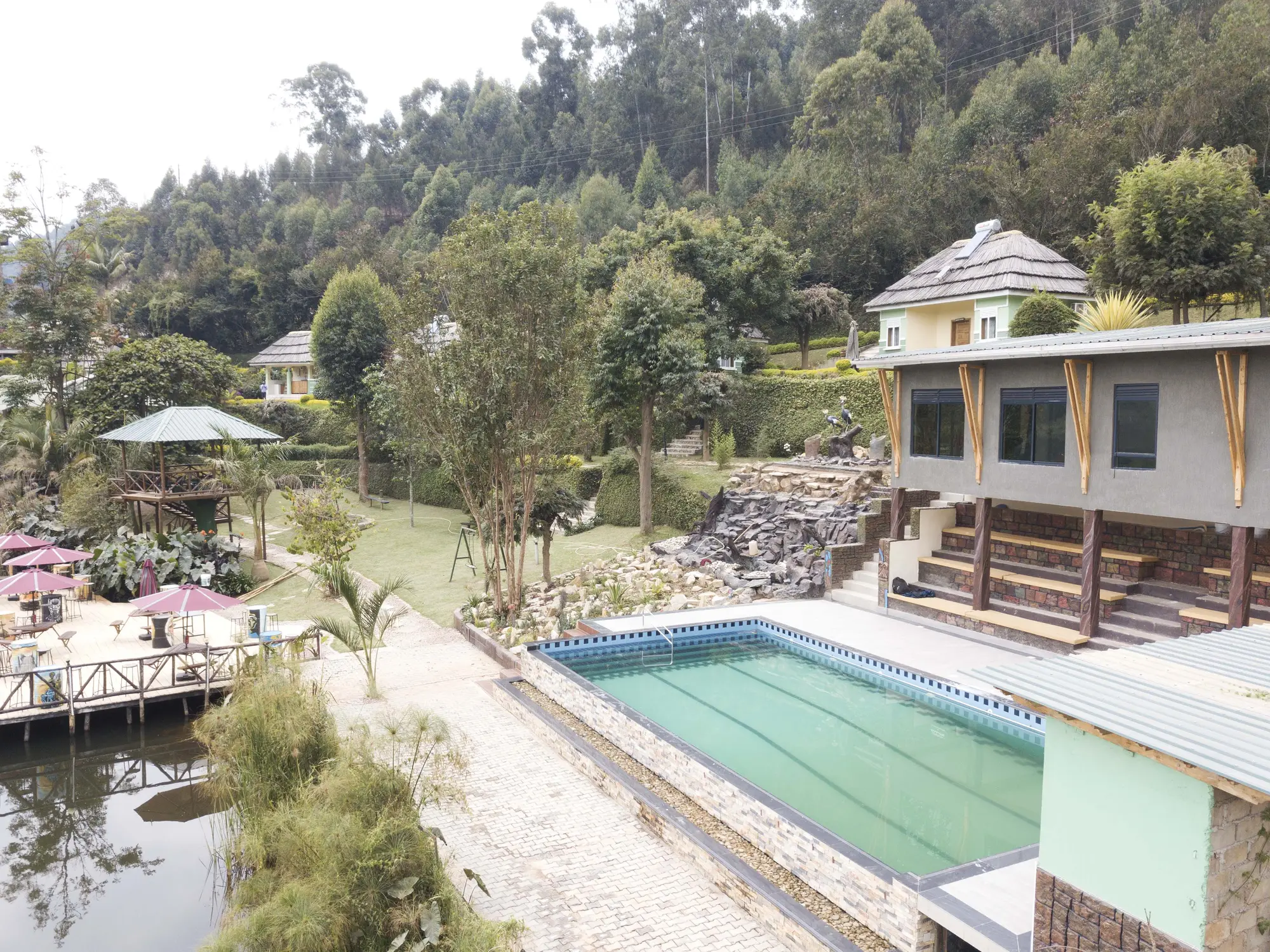 Aerial view of the swimming pool terrace beside the hotel block and the lakeside gazebos