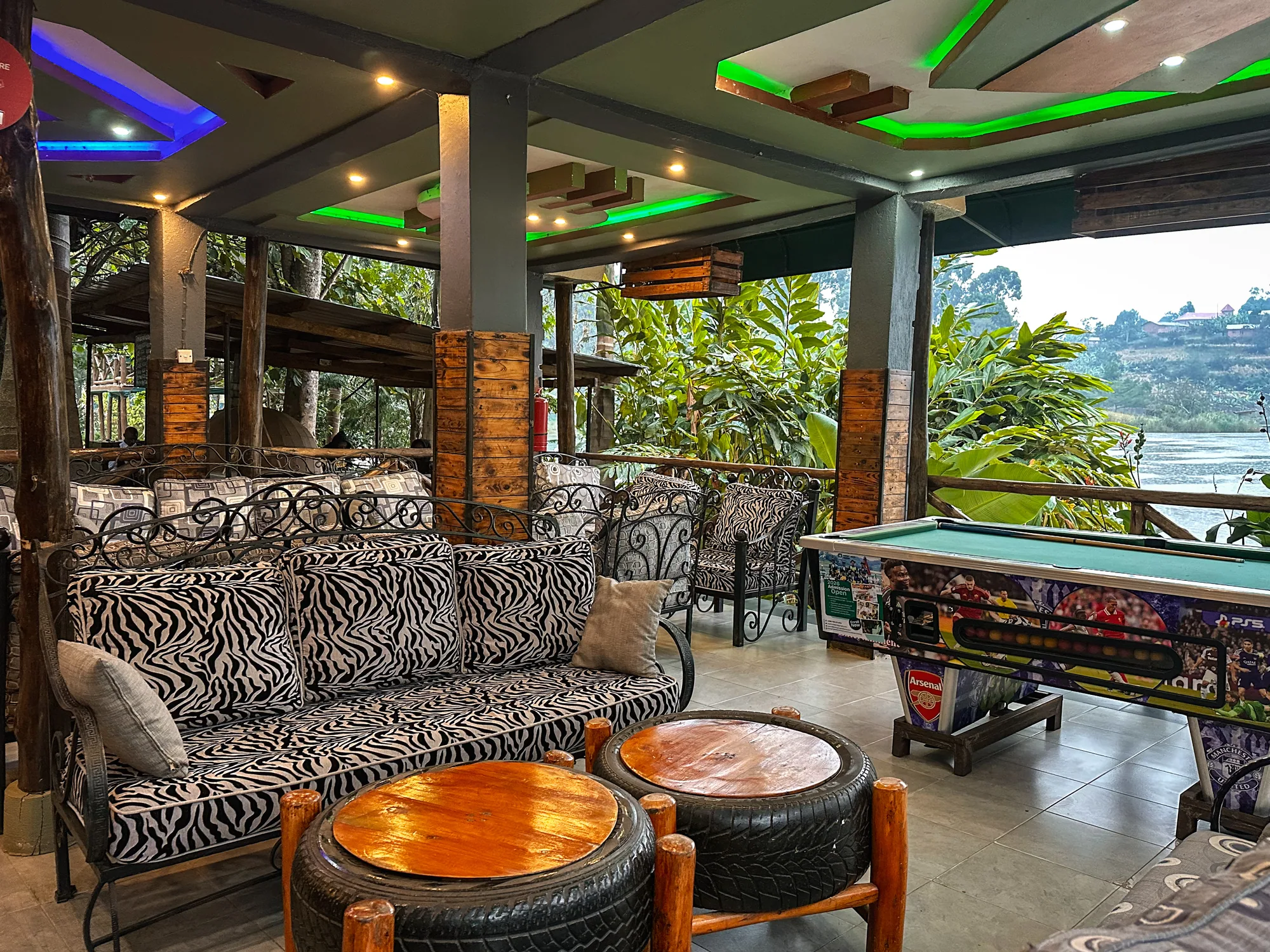 The games lounge seating with tyre-based tables and the pool table beside the open lake-facing side