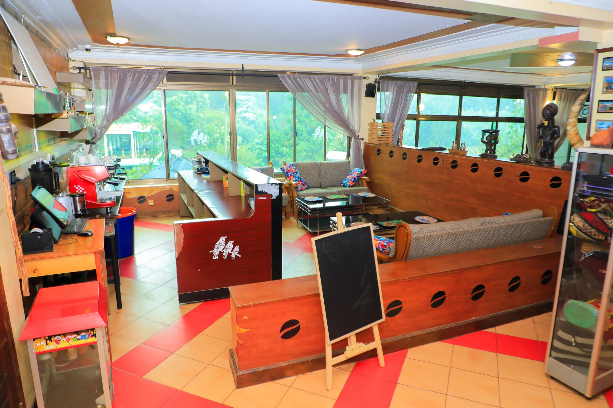 The games room with a foosball table and a long timber bar counter on red and white tiles