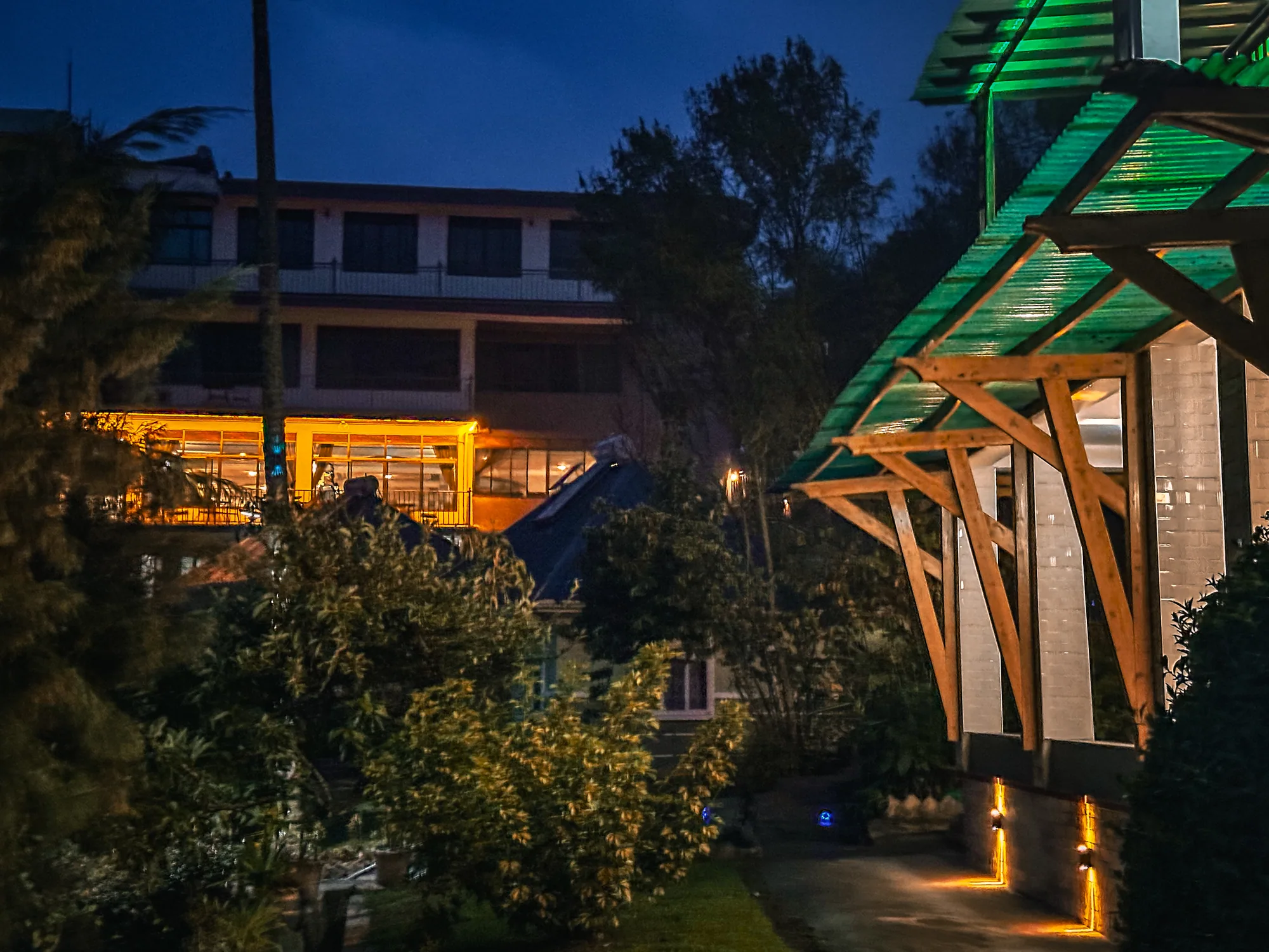 The lodge frontage and timber portico lit up in the evening