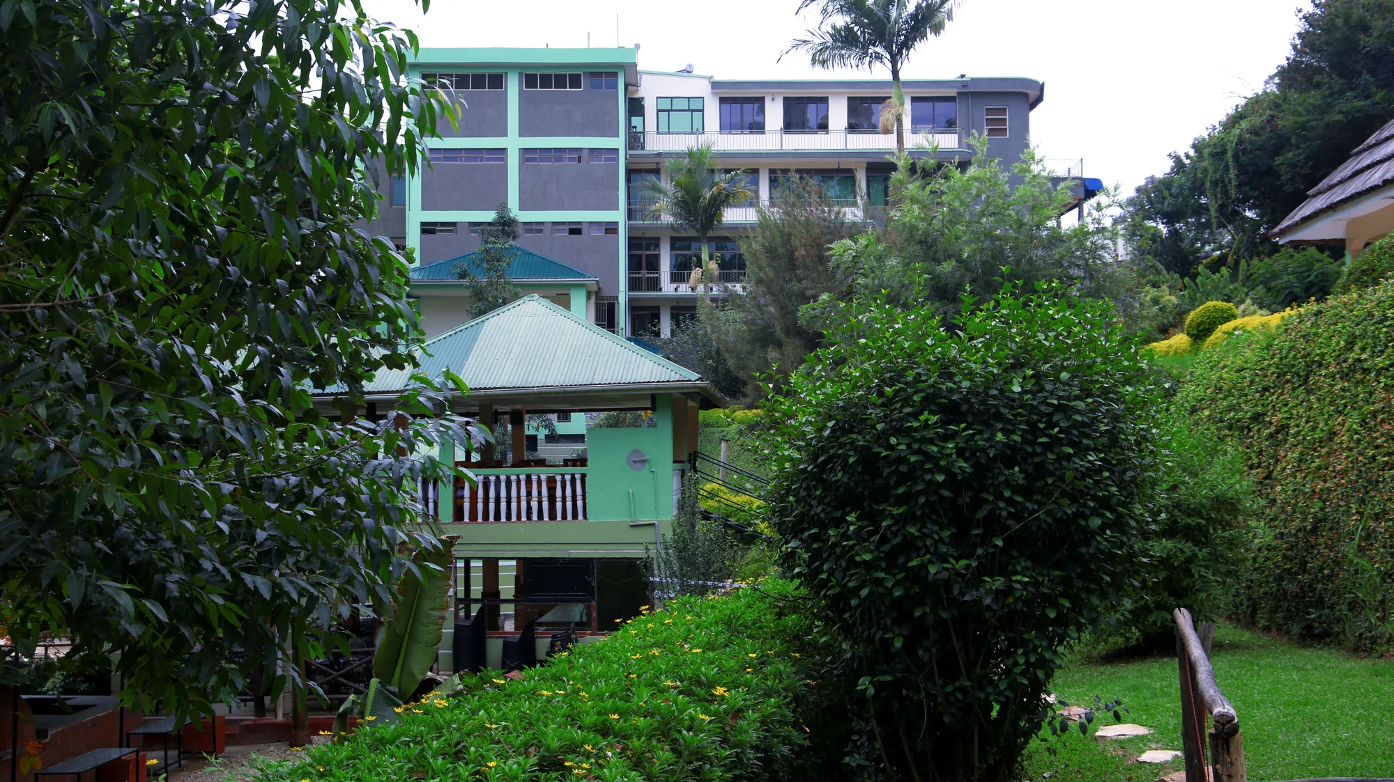 The main hotel building above the resort gardens with a raised timber viewing deck among the trees