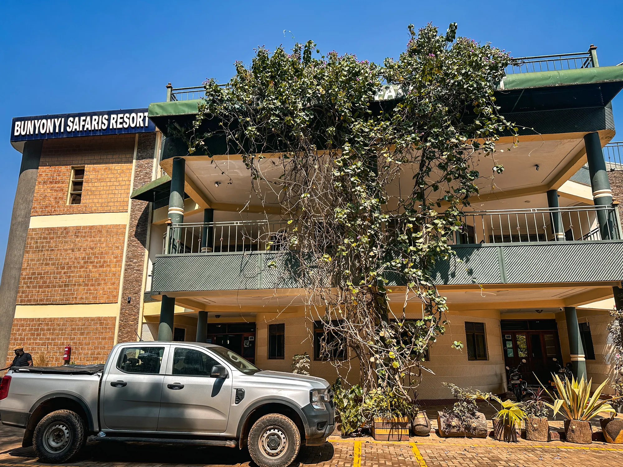 The Bunyonyi Safaris Resort signed building frontage with a pickup parked outside