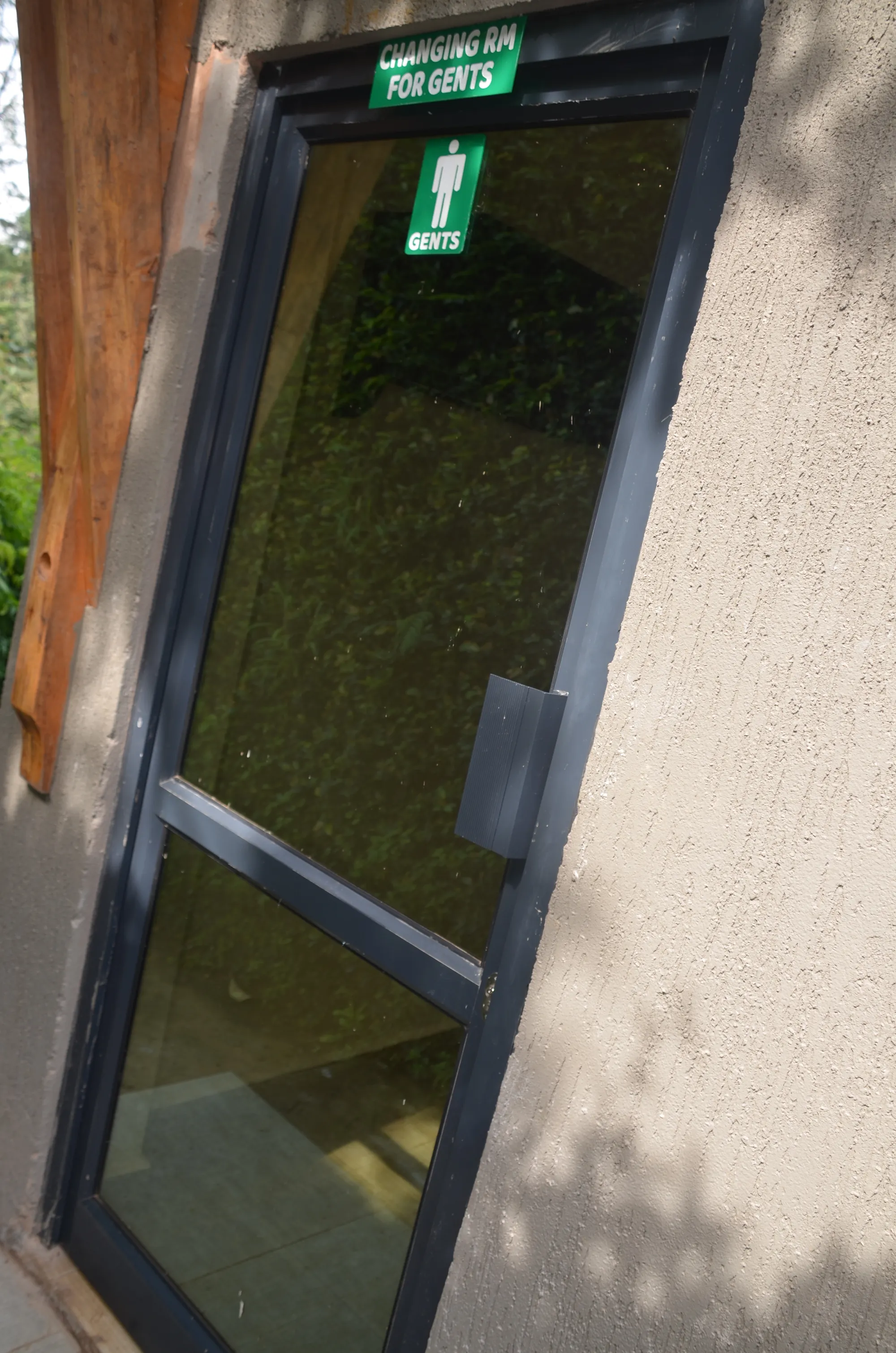 A glazed emergency exit door set in a rendered wall