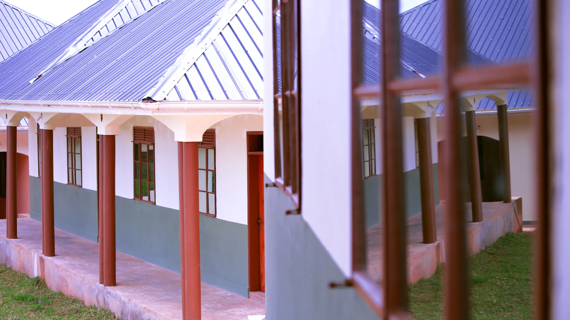 A close view of the columns and pink-trimmed veranda of an institute block