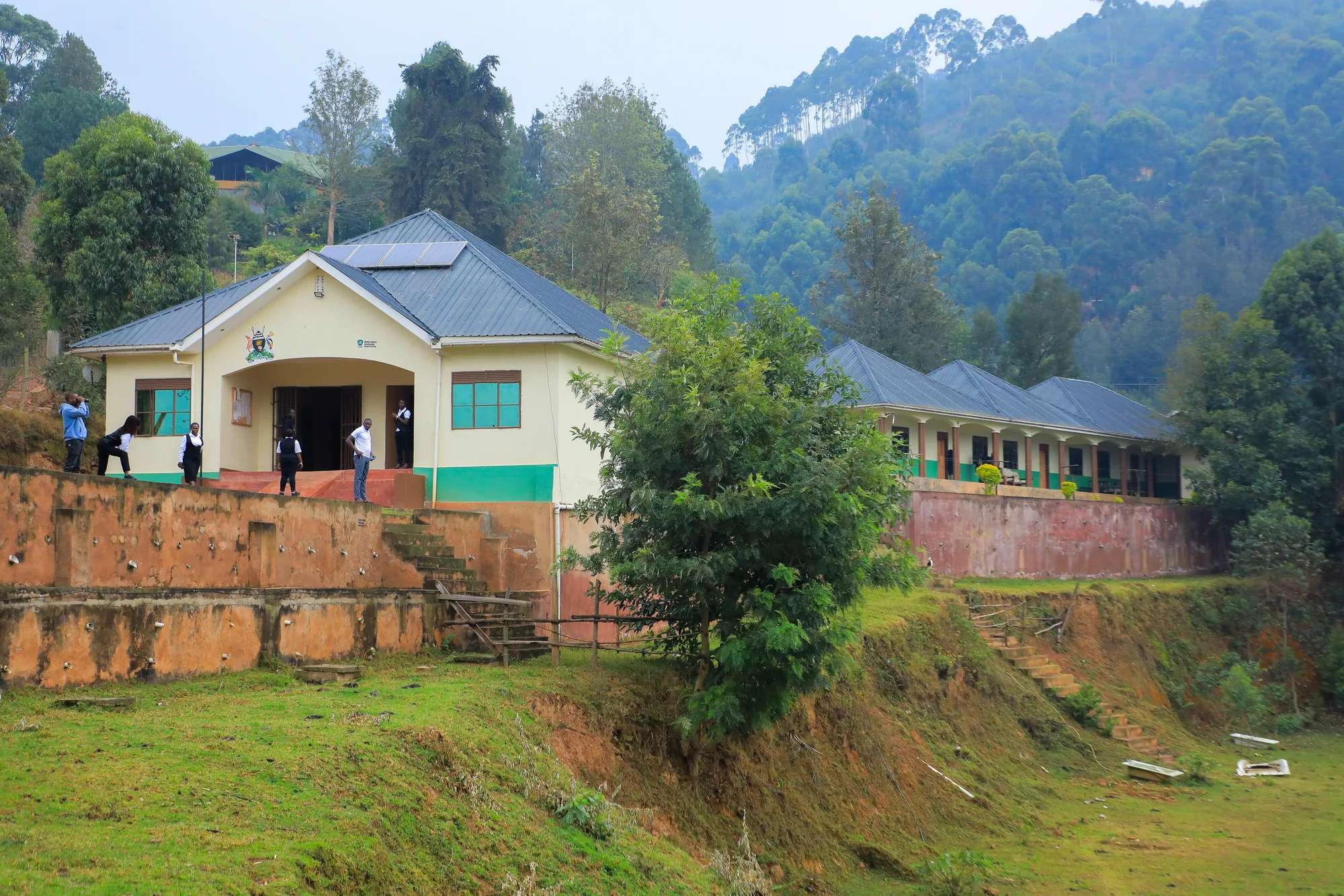 The institute buildings on their terraced site, with students at the doorway