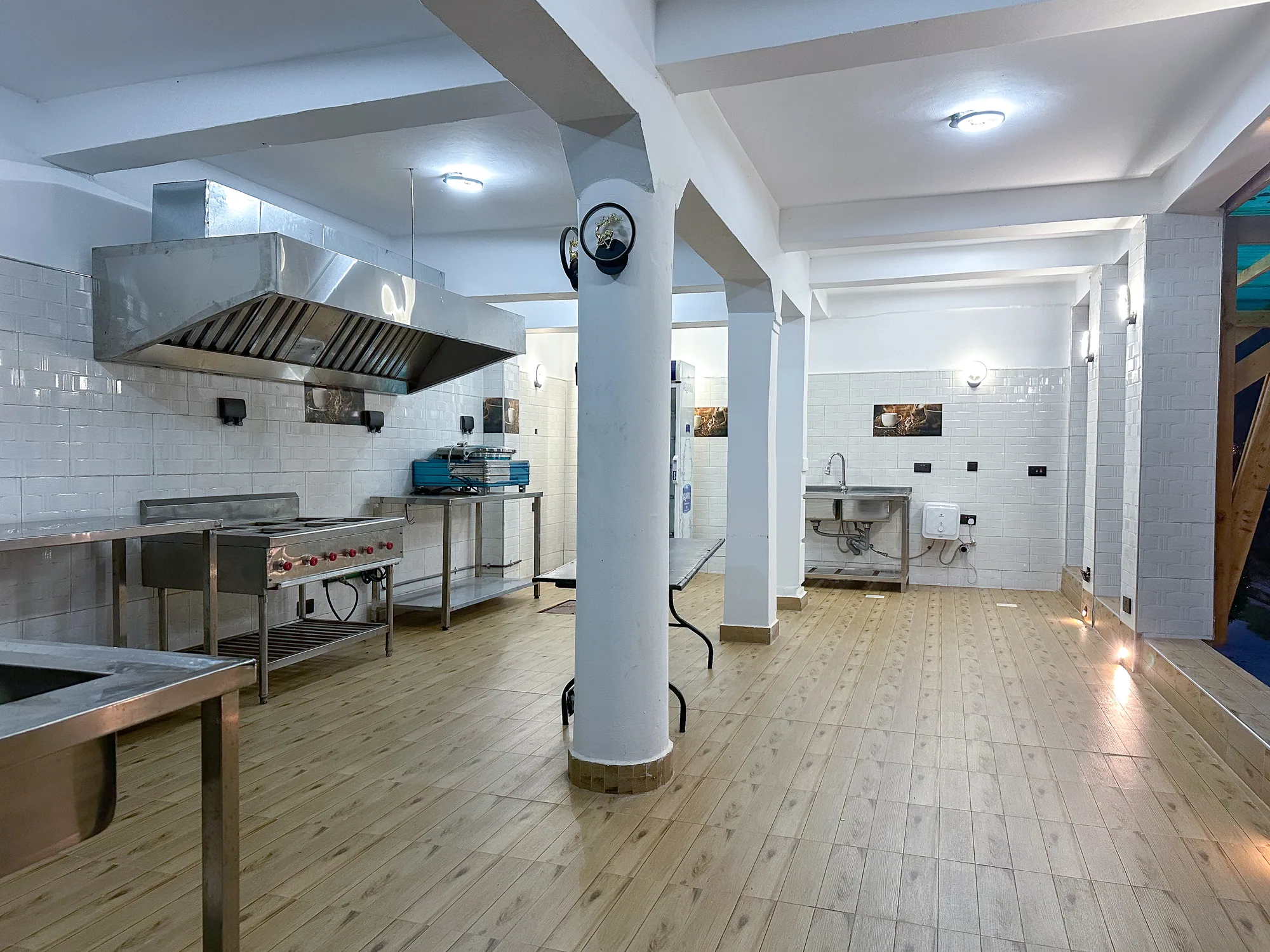 The kitchen from the doorway, ranges under the extraction hood along the wall