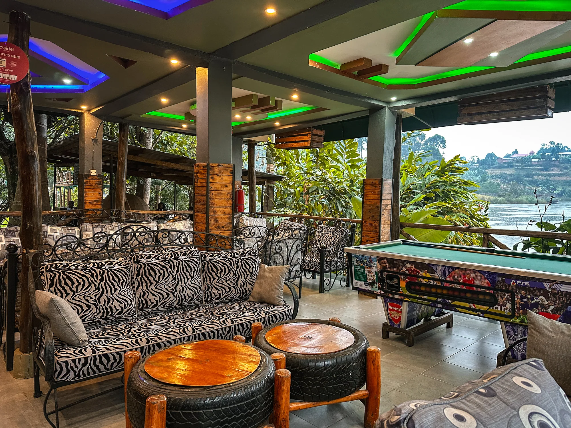 The games lounge from the other end, wrought-iron sofas and the pool table by the open side