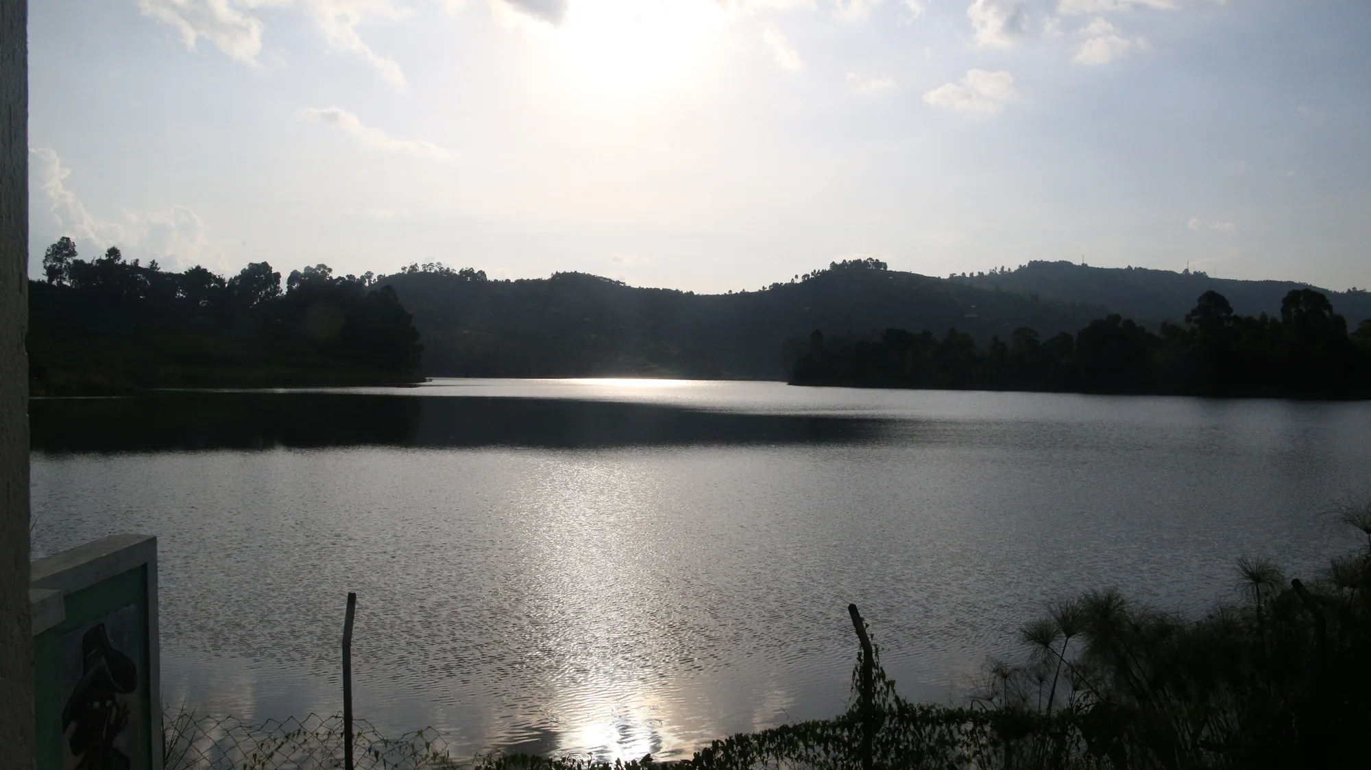 The sun setting over Lake Bunyonyi with the ridges silhouetted against the water