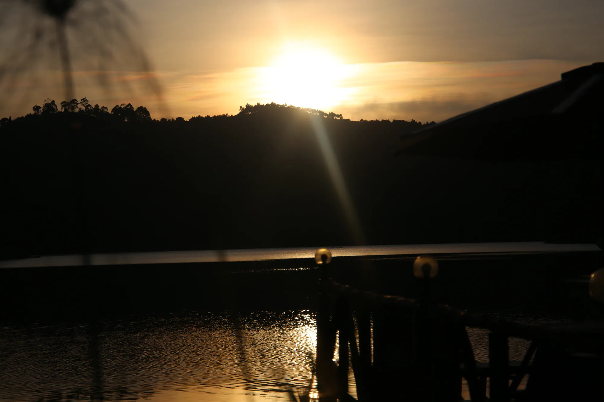 Golden sunset over Lake Bunyonyi from the water's edge