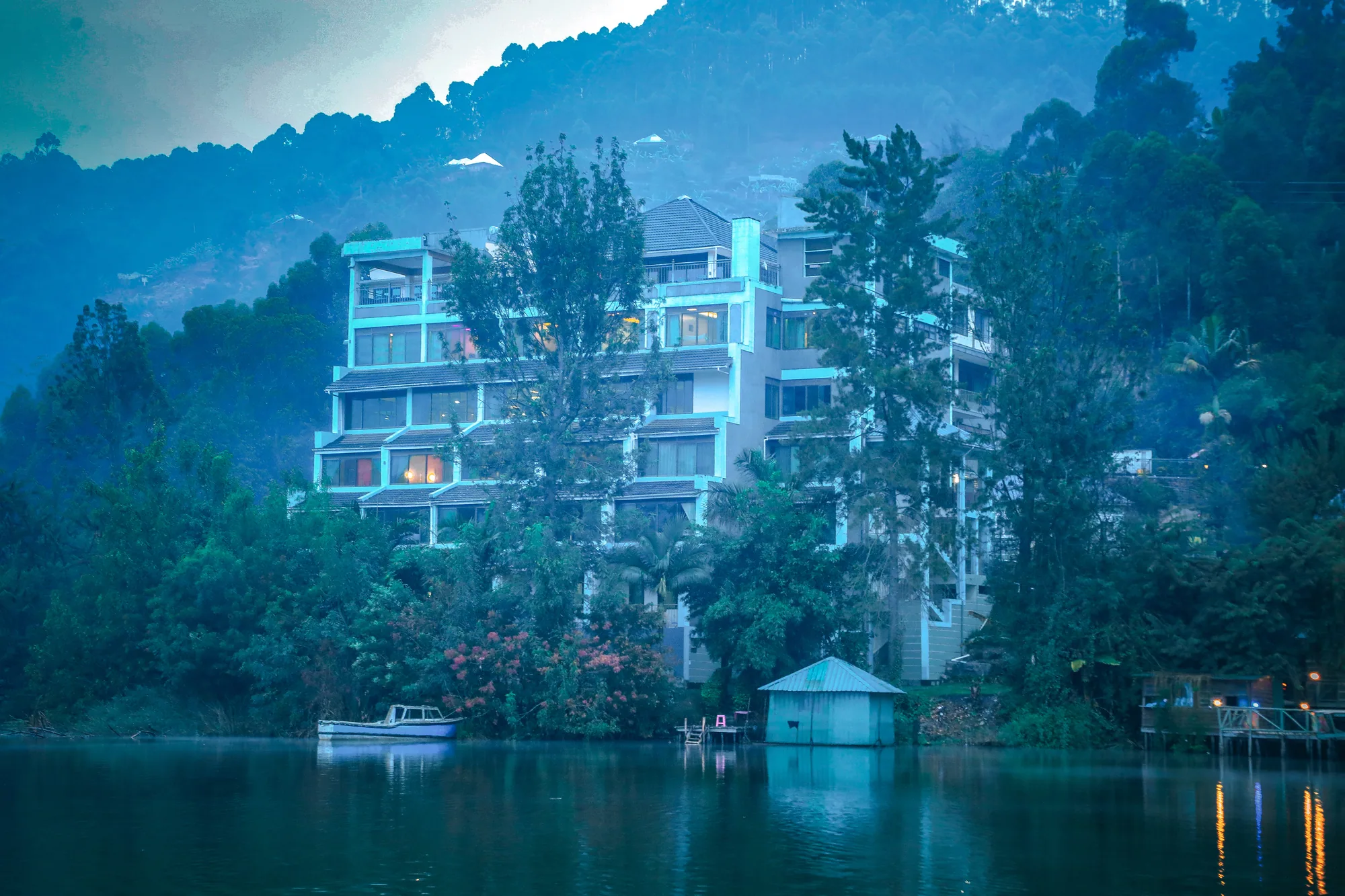 The hotel block above the shoreline in cool blue morning light