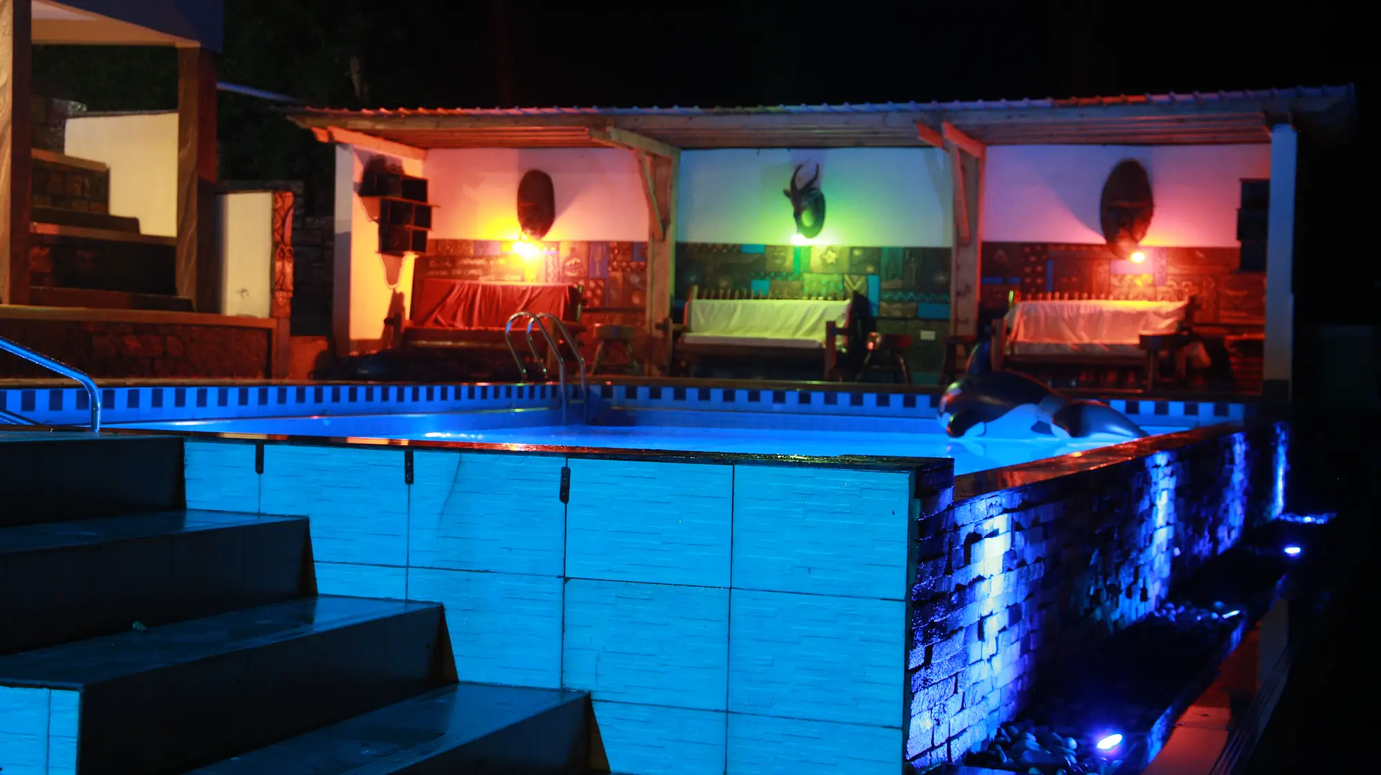 Illuminated swimming pool and steps at night