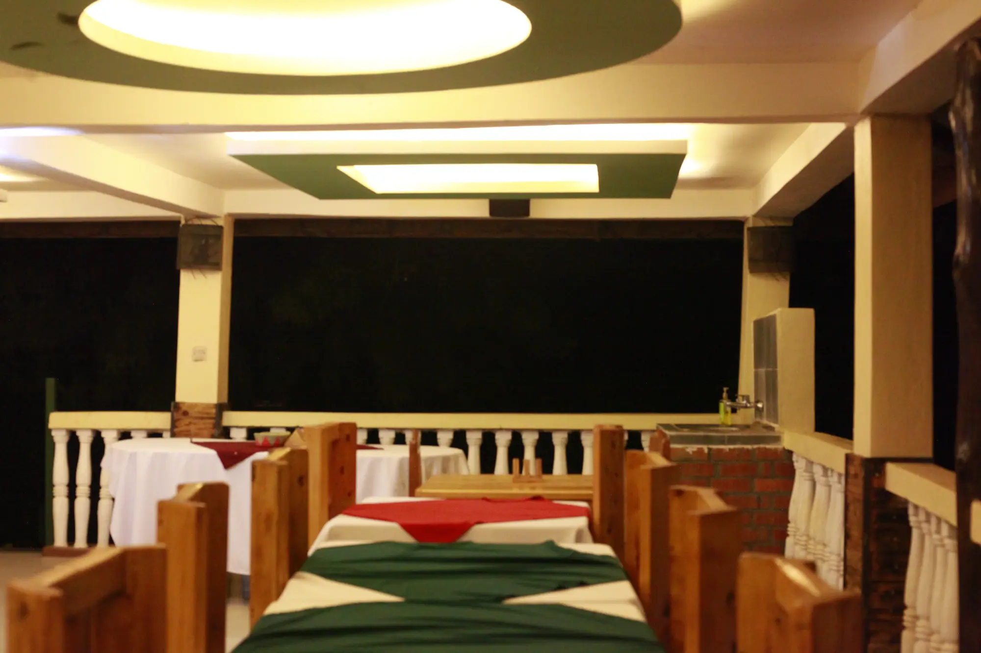 Restaurant interior with laid tables under coved ceiling lighting