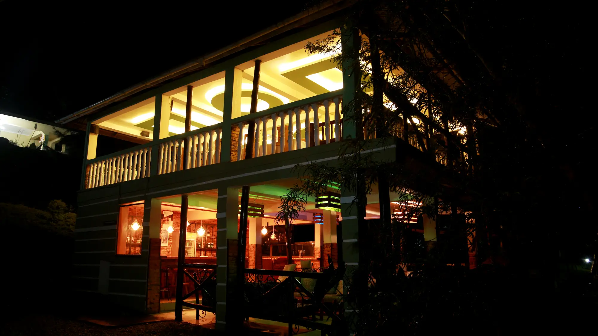 Open-sided restaurant building warmly lit at night