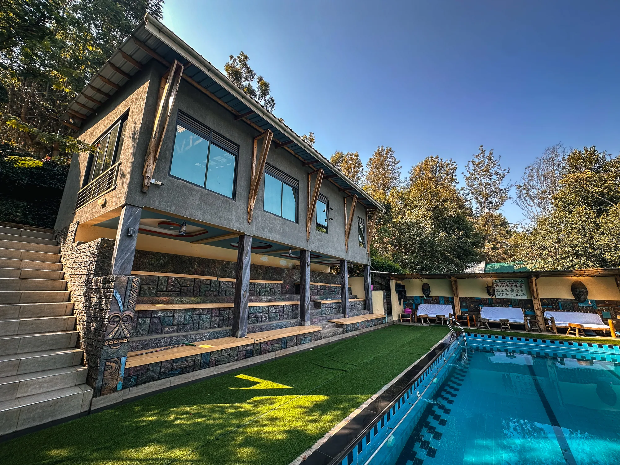 The pool and stairway up to the guest rooms, lawn on the near side