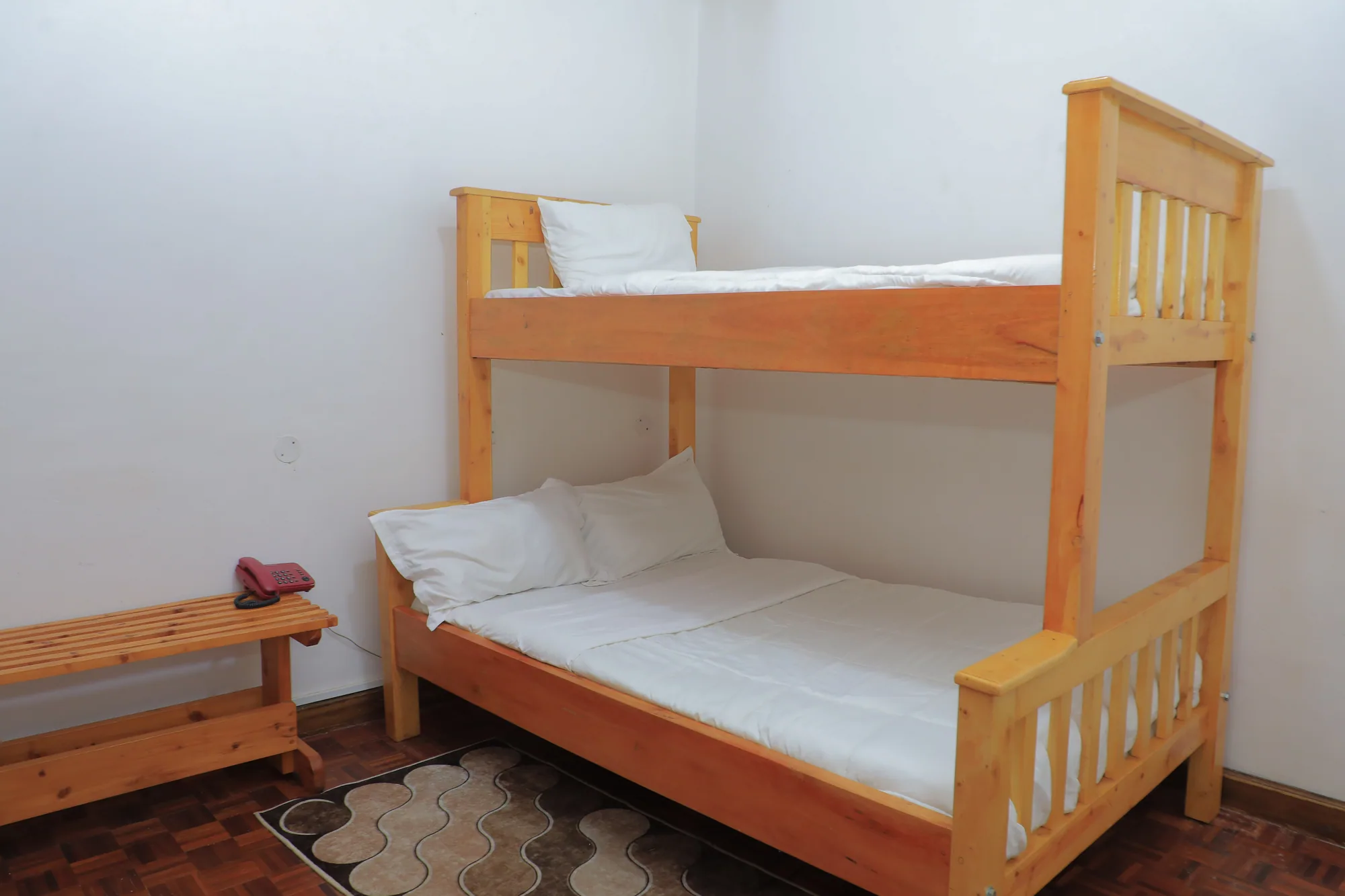 Family Suite: room with a wooden bunk bed made up with white linen