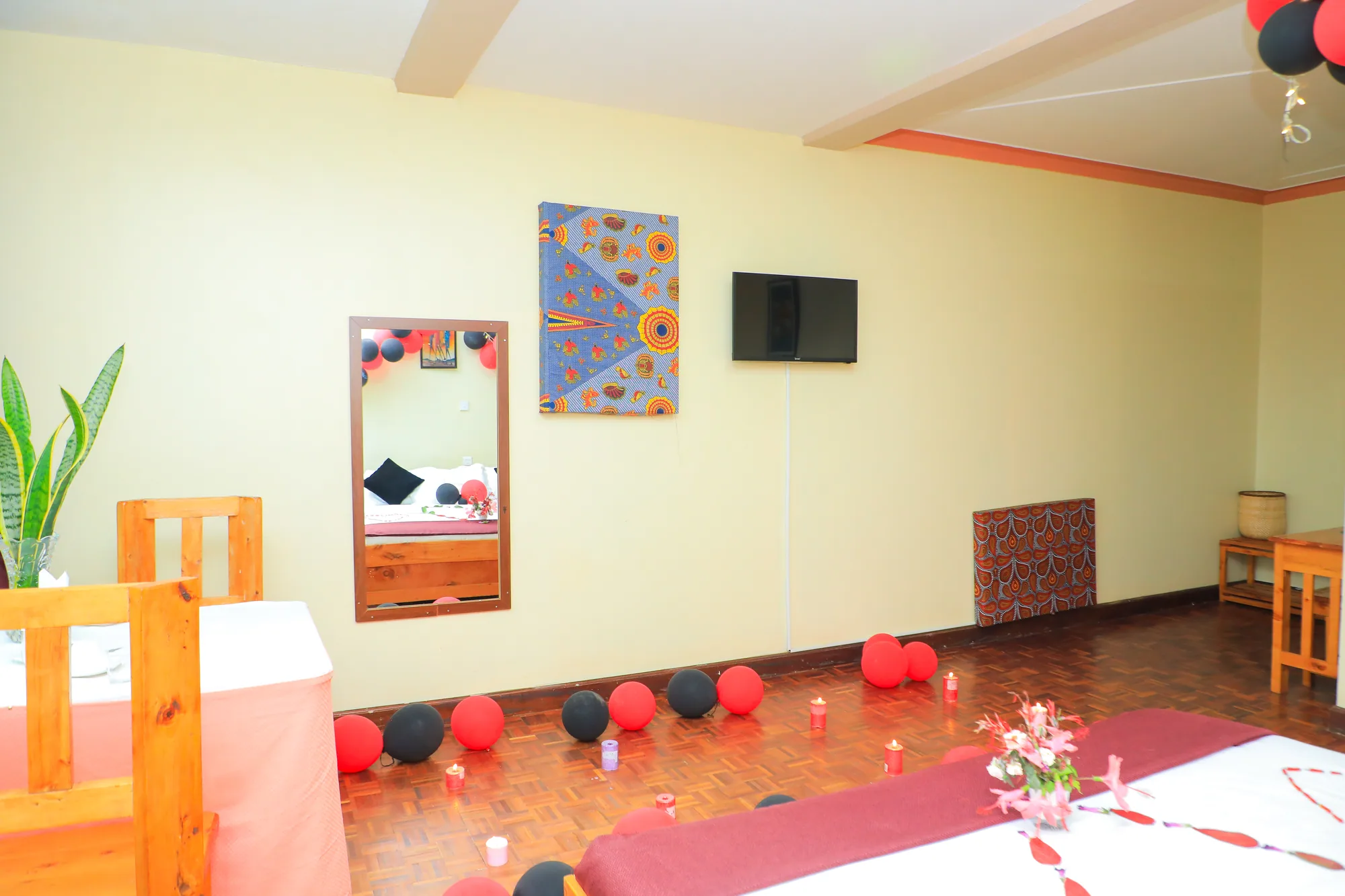 Deluxe Triple Room: room decorated for a celebration with red balloons and petals along the floor