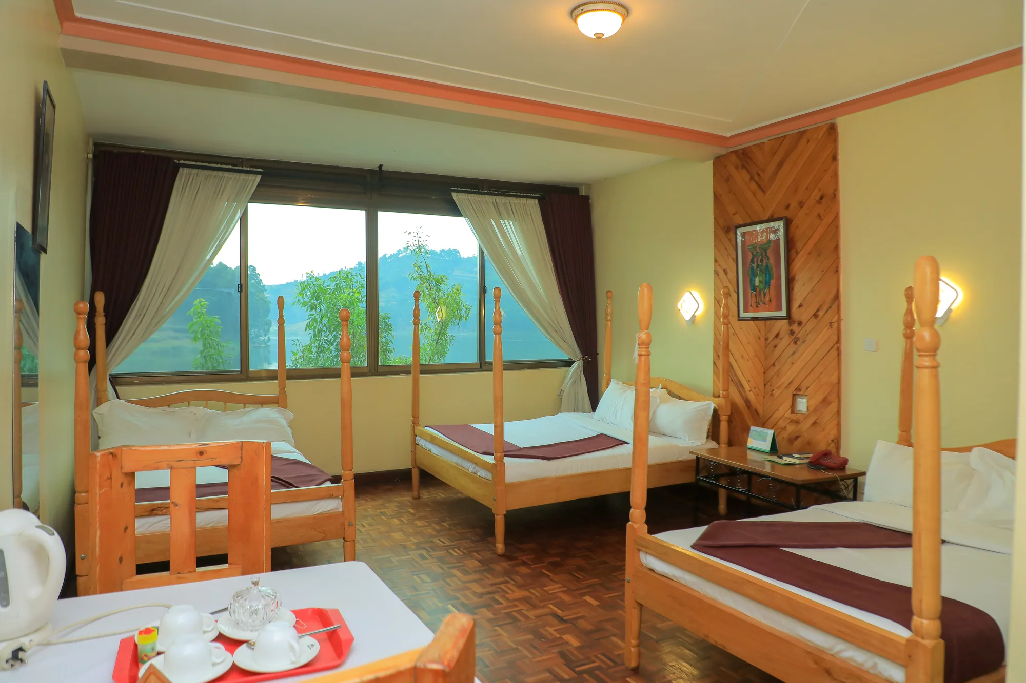 The same triple room with a tea tray on the table between the beds
