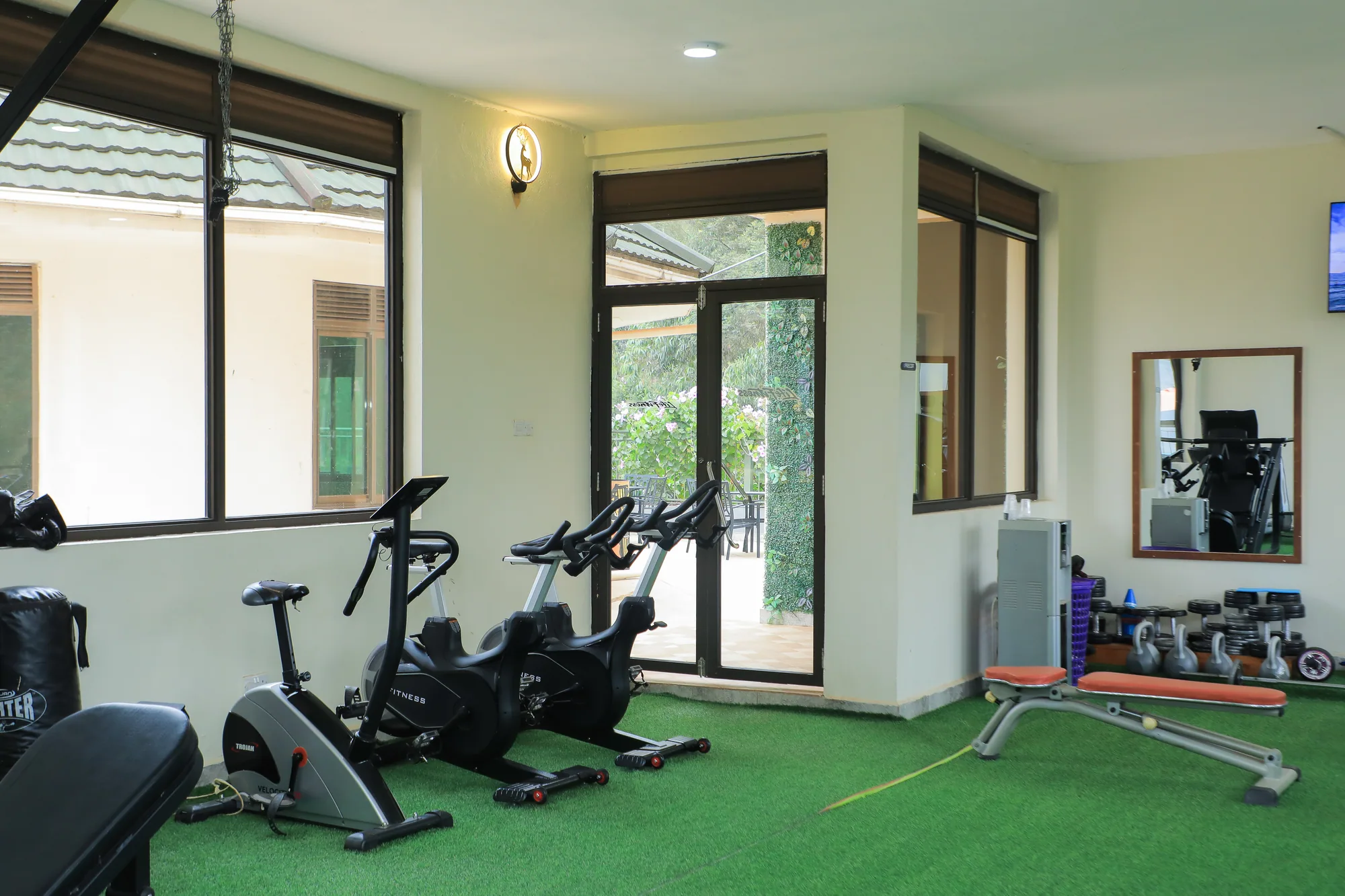 The gym corner with exercise bikes, a mirror and weight machines