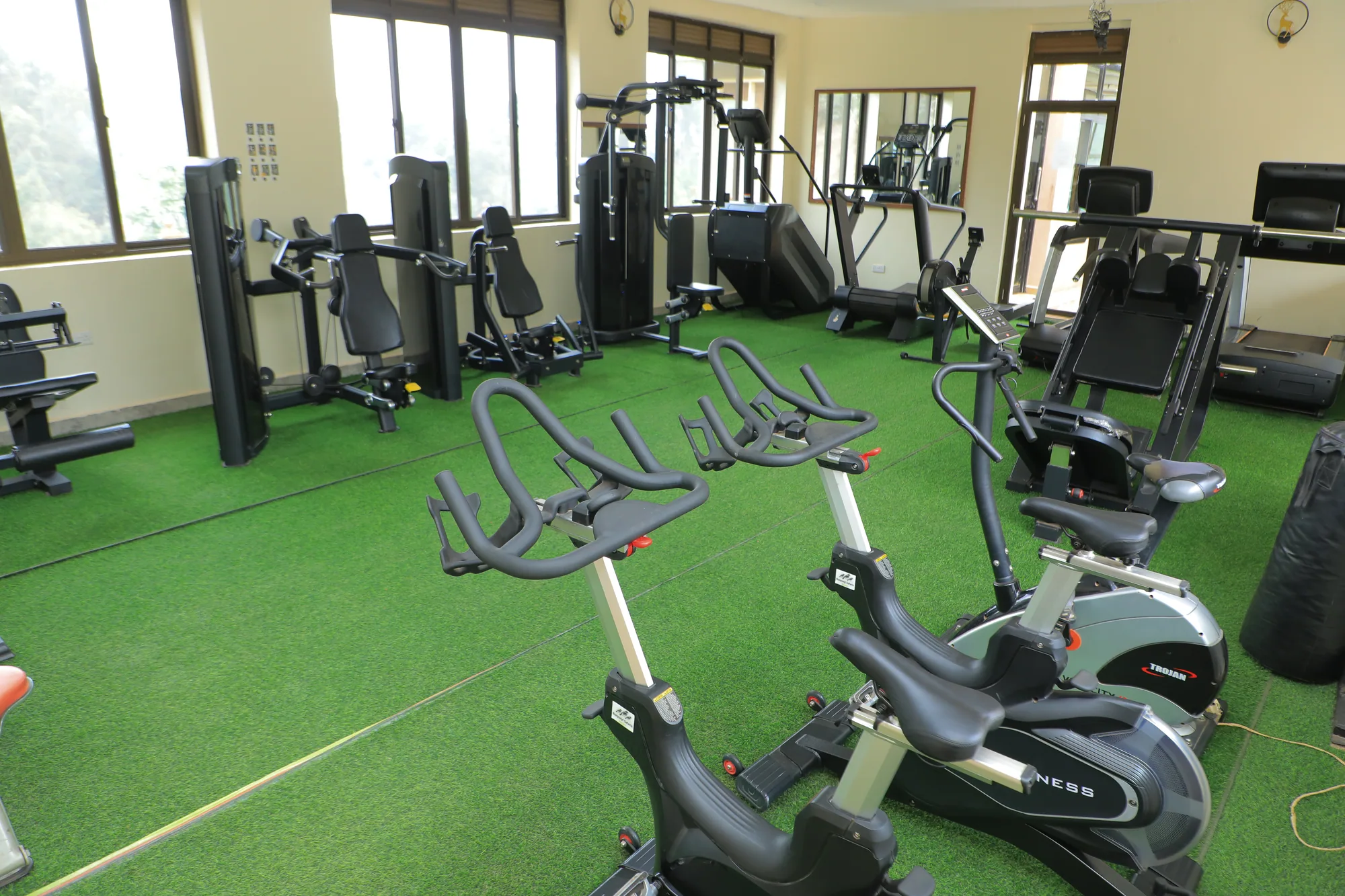 The gym with spin bikes in the foreground and weight stations behind