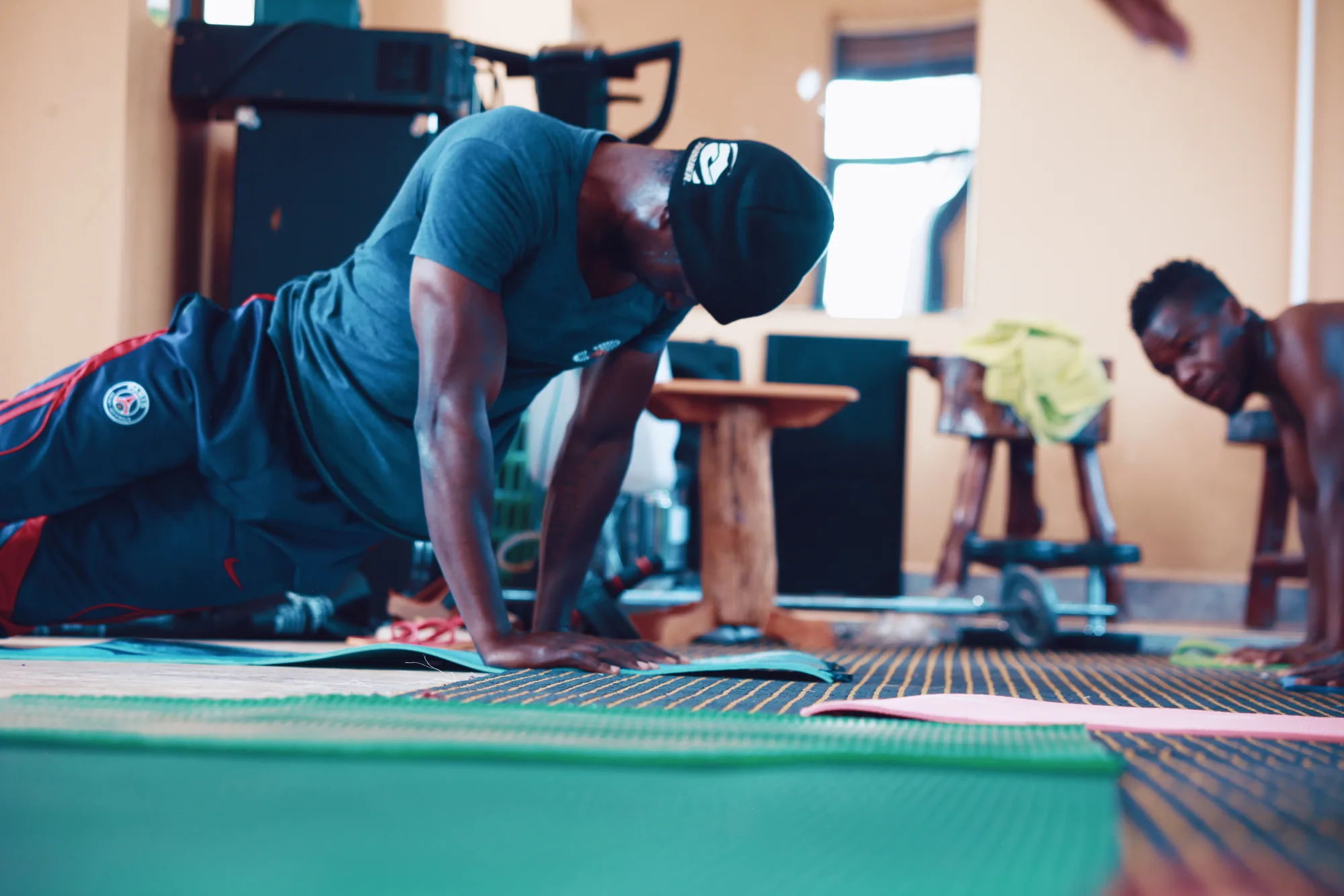 A guest holding a plank on a mat during a gym session