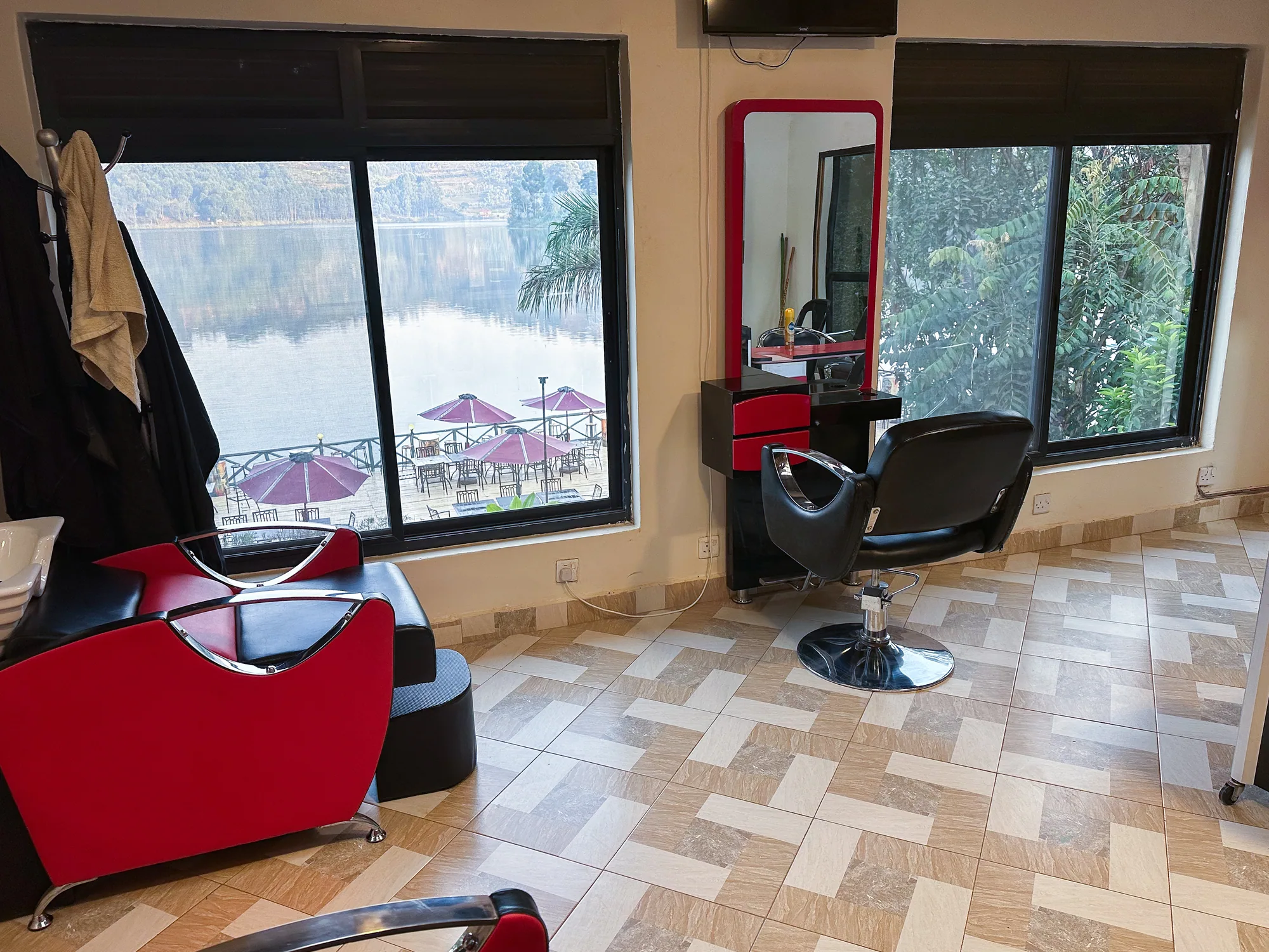 The salon's red and black chairs with windows looking onto the lake