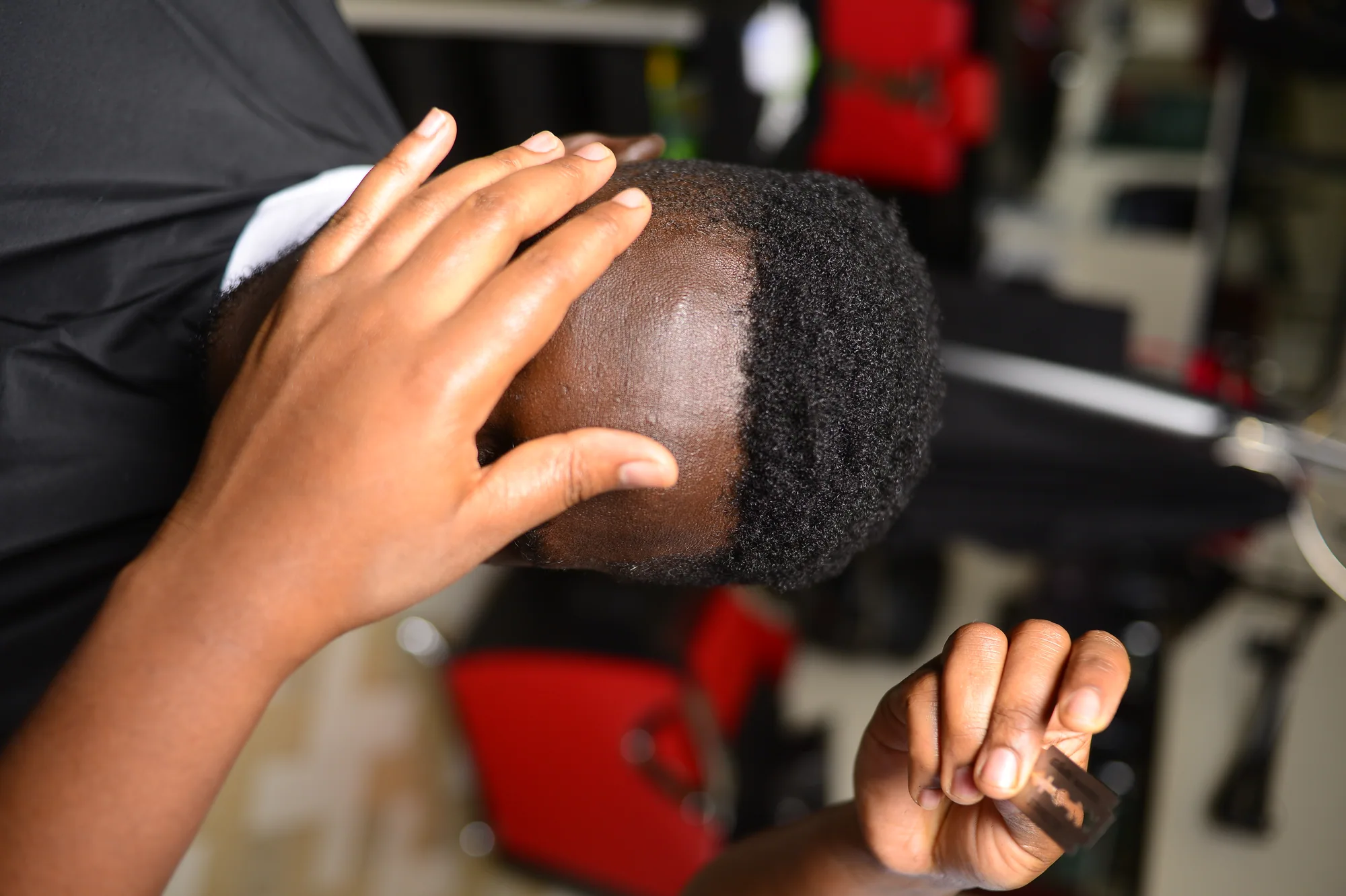 Close view of a client's hair being worked on in the salon